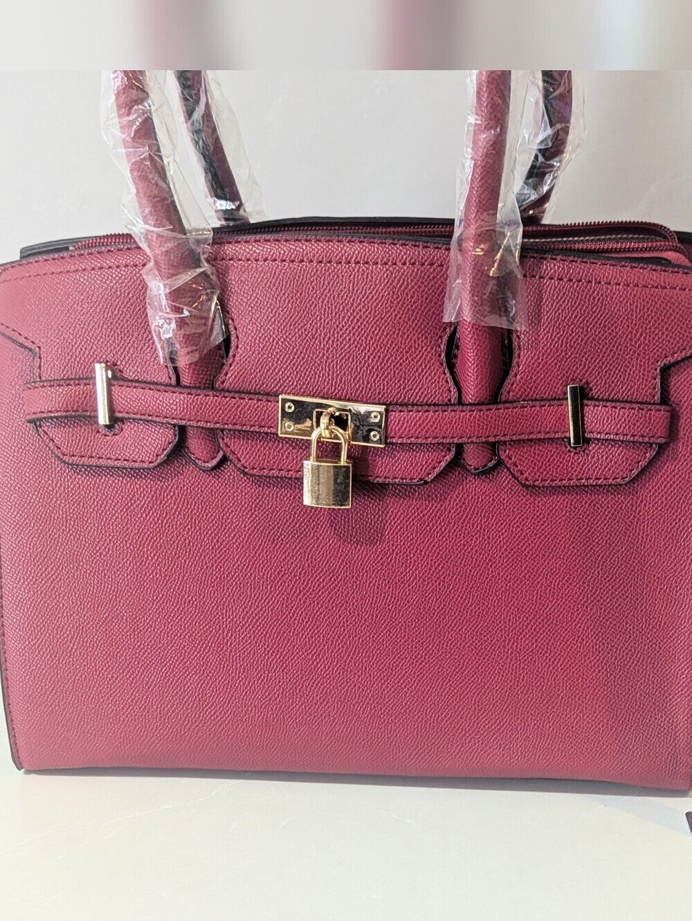 Elegant Burgundy Satchel Handbag with Gold Lock and Matching Wallet